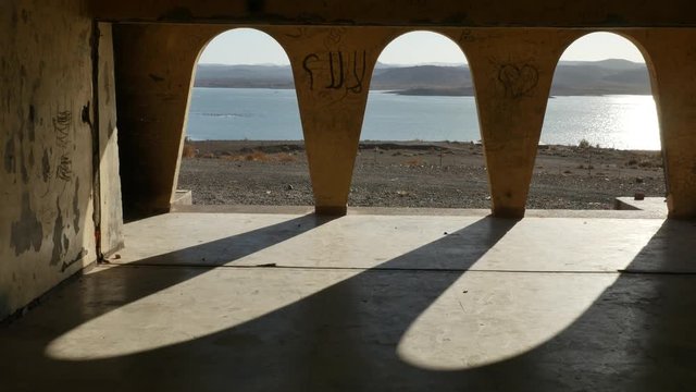 Abandoned kashbah near Lake formed by the el mansour eddahbi barrage near Ouarzazate Morocco 