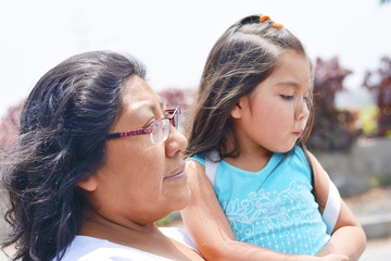 Sad latin woman with her little daughter.