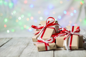 Christmas gift box against bokeh background. Holiday greeting card