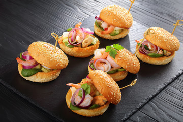 grilled burgers with seafood on stone tray
