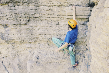 The climber climbs the rock.
