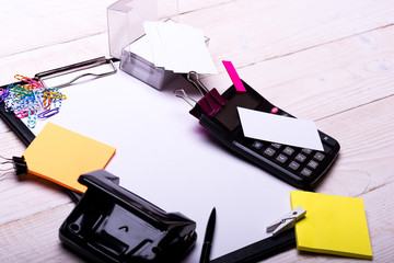 Business cards and binders near sticky notes on clip folder