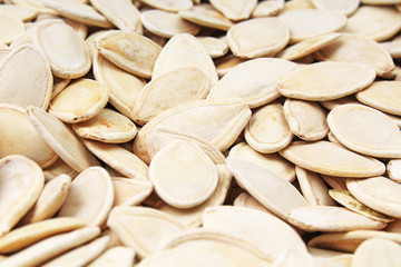 Pumpkin seeds as background. Pumpkin seed texture pattern food photo. Stack of Pumpkin seeds.