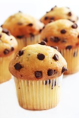 Chocolate chip muffins on white background, selective focus