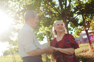 Nice elderly couple in a summer park