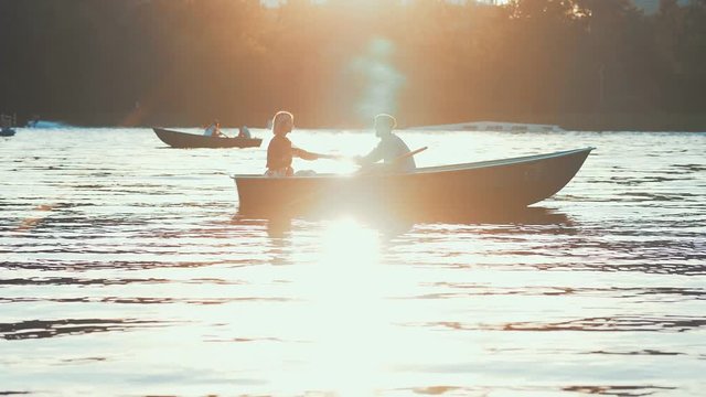People in a boat at sunset