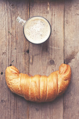 Cup of coffee and croissant