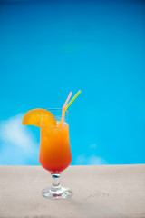 Cocktail next to swimming pool, summer vacation concept