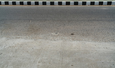 Black and white concrete road curb
