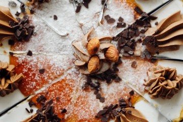 Delicious cake with chocolate cream and almonds  