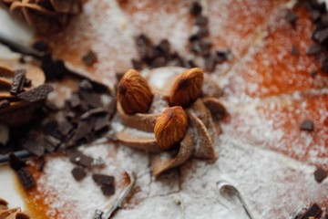 Delicious cake with chocolate cream and almonds  