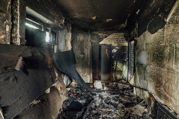 Burnt apartment house interior. Burned furniture and charred walls in black soot