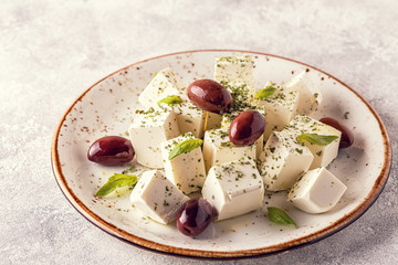Greek cheese feta with oregano and olives.