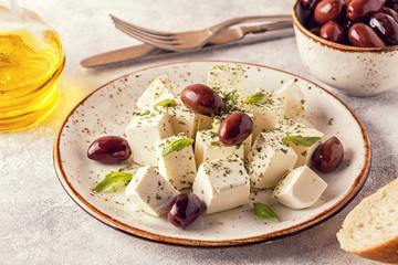 Greek cheese feta with oregano and olives.