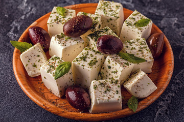 Greek cheese feta with oregano and olives.