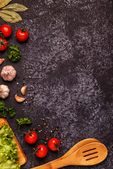 Ingredients for cooking on dark concrete background.