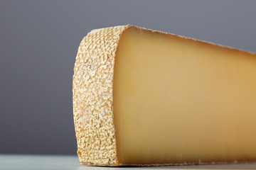 French cheese comté on grey background.