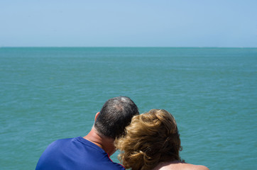 Old couple looking at the horizon, beach, love.