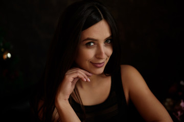 Beauty portrait of young adorable fresh looking brunette woman with long brown healthy curly hair.