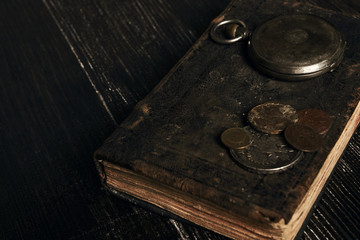 Antique vintage pocket watch and old leather book 