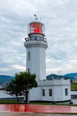 Fototapeta na wymiar Seafront Promenade on Black Sea coast with lighthouse view in Batumi
