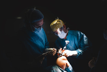 Doctors operating kneecap.