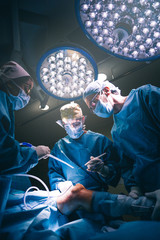 Doctors operating kneecap.