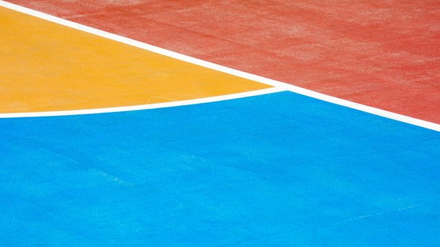 Red, Blue And Yellow Concrete Basketball Court - Close Up