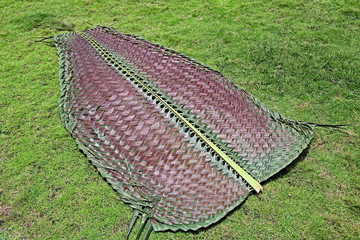 Woven coconut palm leaf by interlocking used as mat, partition wall, fencing, in thatched roofs and...