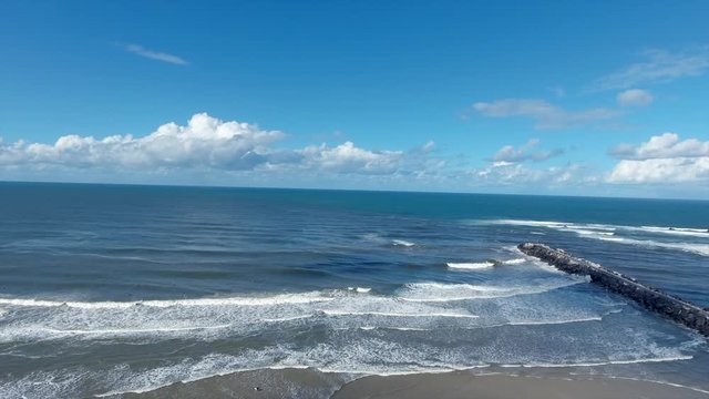 wide blue ocean and jetty