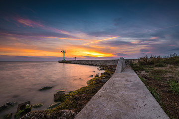 Fototapeta na wymiar Lighthouse in port of Jastarnia at sunset time. Hel Peninsula. Poland.