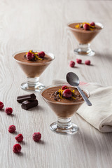 fresh chocolate mousse and raspberry in a glasses.