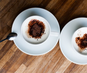 Food. Cup cappuccino coffee, wooden table