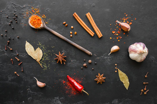 herbs spices and condiments on a black background