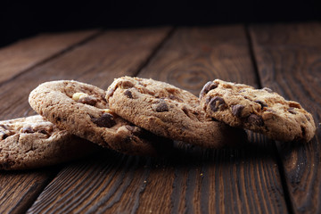 Chocolate cookies on wooden table. Chocolate chip cookies.
