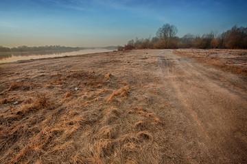 covered with frost withered grass on the bank of the river