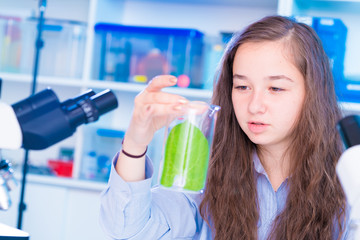 Girl in biology class with leaf  green plants