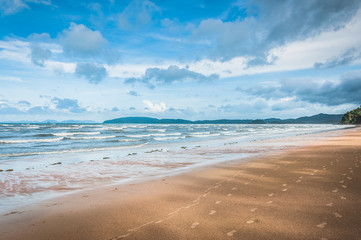 Beautiful sunny beach with blue sky and white clouds on the background