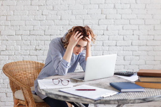 Portrait Of Tired Young Business Woman With Laptop Computer