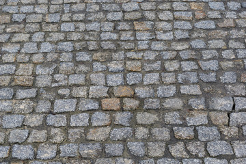 Old wet cobblestone. Paved street.