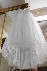 Fototapeta na wymiar Wedding dress on mirror wardrobe