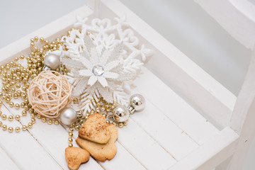 Christmas gift box with ribbon bow  and ball toy and cone on white wooden vintage background