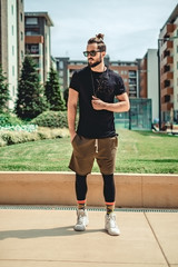 Hipster standing  seriously in the street