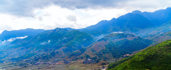 Dramatic clouds sky, natural landscape mountain range at foggy summer morning, green nature background aerial view.