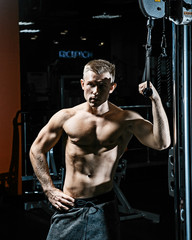 Fototapeta na wymiar Strong man working in gym 