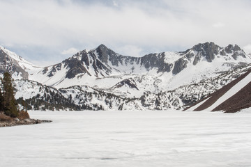 Scenic winter view of a lake and snow covered mountains in California. 