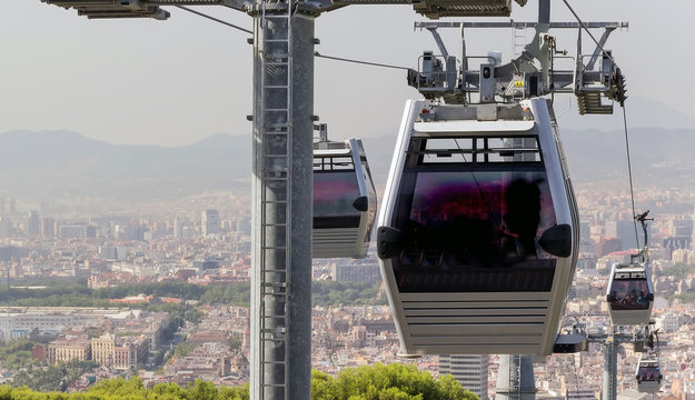 Cable Cars operating with a scenic cityscape of Barcelona, Catalonia, Spain.