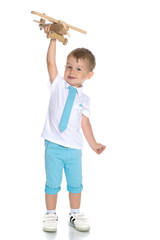Little boy playing with wooden plane