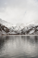 Snow covered mountains with a lake in the foreground in California. 