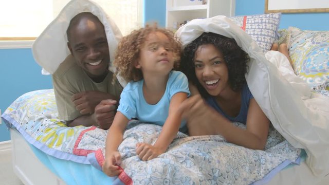 Portrait of African American family in bedroom